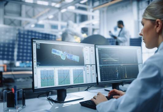 Female Engineer uses Computer to Analyse Satellite, Calculate Orbital Trajectory Tracking. Aerospace Agency International Space Mission: Scientists Working on Spacecraft Construction. Over Shoulder